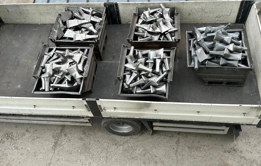 Crates of cast bucket-wheel excavator teeth loaded on a truck bed
