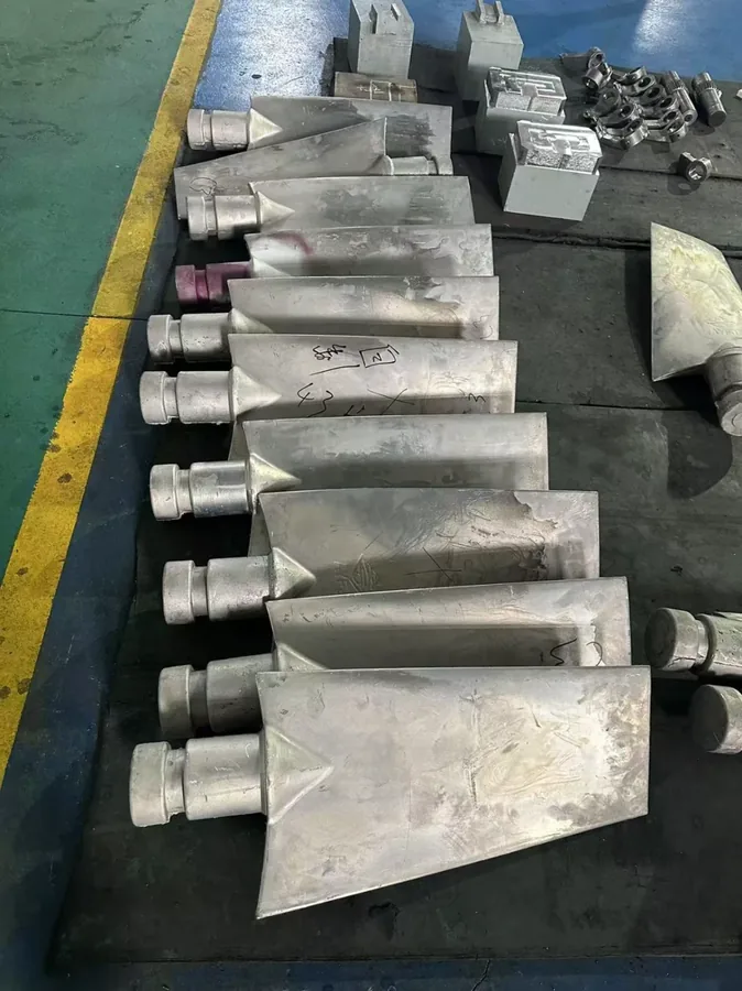 Cast bucket teeth stacked on the shop floor