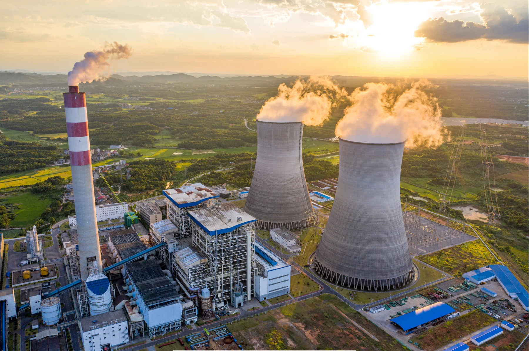Thermal power plant with two cooling towers at sunset
